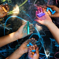 Group of kids playing with colored chalks
