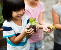 Kids holding plants