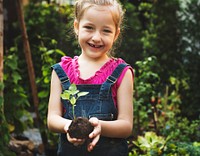 Little girl holding a plant