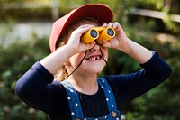 Little girl using binoculars