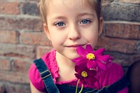 A girl is smiling with flower
