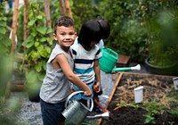 Group of children watering organic fresh agricultural product