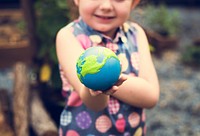 Little girl is holding a planet ball