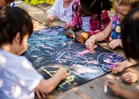 Group of kindergarten kids friends drawing art class outdoors