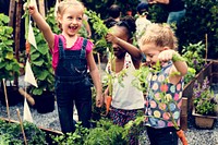 Group of kindergarten kids learning gardening outdoors