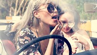 Woman Sitting in a Car Putting Lipstick on Lips with Rear Mirror