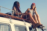 Women Sitting on The Roof of the Van Traveling Road Trip