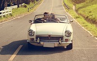 Couple Driving a Car Traveling on Road Trip Together