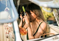 Woman Taking Photo by Retro Camera on Road Trip