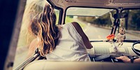 Woman Sitting in a Car Put Head Out of Window Wind Blowing Her H