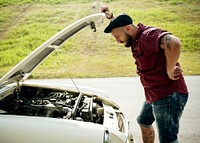 Men Checking Broke Down Car on Street Side with Open Hood