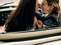 Women Couple Driving a Car Road Trip Together