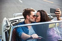 Couple Driving a Car Traveling on Road Trip Together