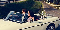 Couple Driving a Car Traveling on Road Trip Together