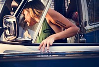 Woman Getting in a Car on Front Seat of The Car Road Trip Travel