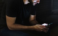 Man Using Mobile Phone in the Dark