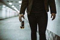 Alcoholic Homeless Holding Liquor Bottle