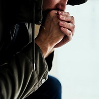 Closeup of homeless sitting thoughtful