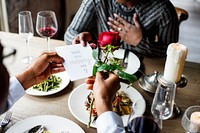 Man giving a rose and propose for the lady at dinner