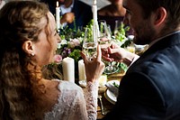 Bride and Groom Toasting with Wine Glasses at a Wedding Reception