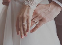 Bride and groom&#39;s hands with their wedding rings