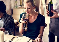 Woman Tasting Red Wine in a Classy Restaurant