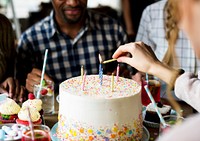 Woman Lighting Up Candles on Cake on Her Birthday Party Celebration