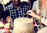 Woman Lighting Up Candles on Cake on Her Birthday Party Celebrat