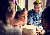 Woman Blowing Candles on Cake on Her Birthday Party Celebration