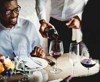 Restaurant Staff Poring Serving Red Wine to Customers