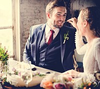 Bride feeding her groom cake