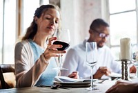 Woman Holding Red Wine Glass in a Classy Restaurant