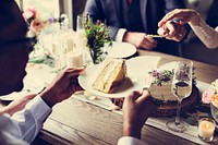 A slice of cake at the wedding reception table