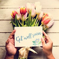 Hand Holding Show Get Well Soon Card with Tuips Flowers Backgrou