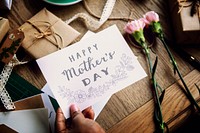 Hand Holding Show Happy Mother Day Card with Flowers Background