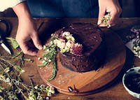 Baker Man Decorating Chocolate Cake with Flowers