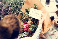 Florist Making Fresh Flowers Bouquet Arrangement with Happy Mother Day Card