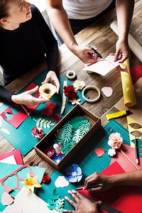 Aerial view of messy paper craft work table