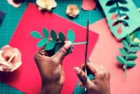 Hands Using Scissor Cutting Paper to Leaf Design Handicraft