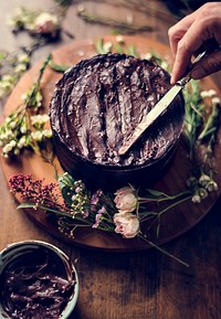 Baker Hand Using Spatula with Chocolate Cake