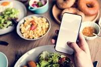 Hand Holding Mobile Phone with Empty Copy Space Screen with Food