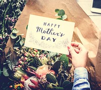 Hands Holding Happy Mother Day Greeting Card with Flowers Bouque