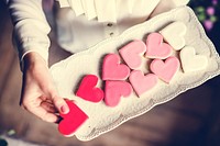 Woman carry a plate of heart shaped sweet biscuit