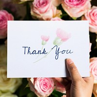 Hand Holding Show Thank You Card with Flowers Background