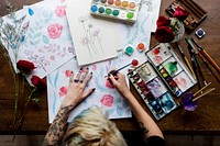 Woman drawing colorful flower in aerial view