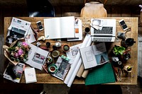 Designer messy workspace on wooden table