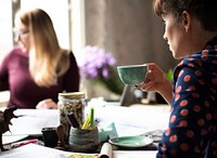 Woman Sipping Coffee from Cup on Office