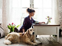 Woman working at home with her dog