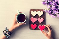 People Hands Showing Heart Shape Cookies with Coffee Cup