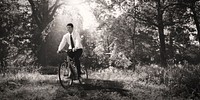 Businessman biking through a forest